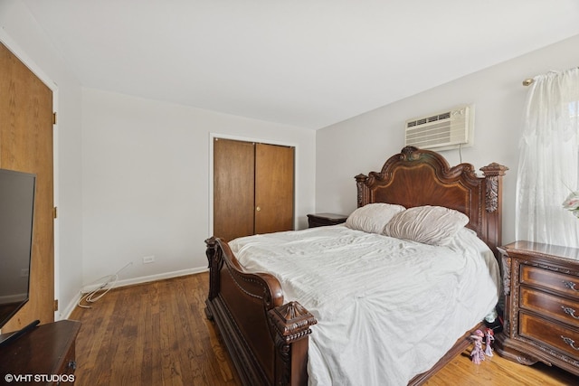 205 Circle Ave Unit 2B, Forest Park, IL 60130 - bedroom with a wall unit AC, a closet, wood finished floors, and baseboards