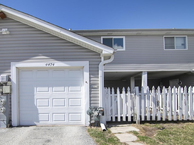 exterior space with fence and an attached garage