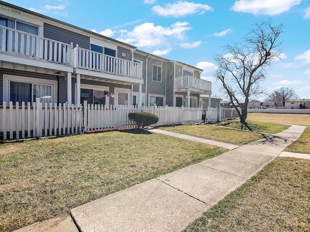 view of property's community with a lawn and a fenced front yard
