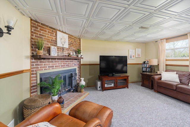 carpeted living room with baseboards, an ornate ceiling, and a fireplace