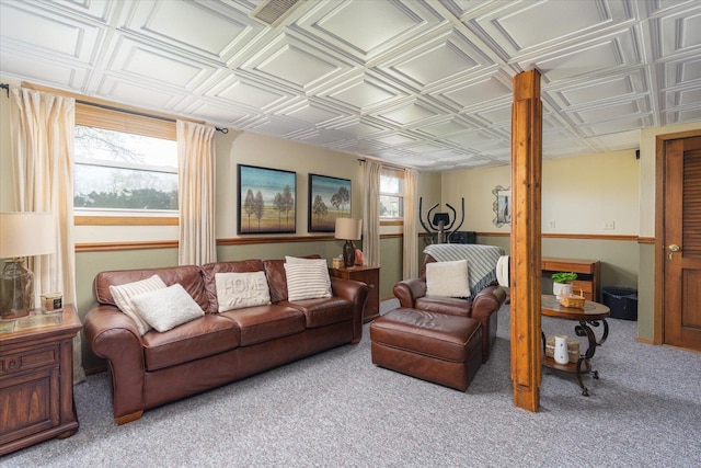 living area with carpet floors and an ornate ceiling