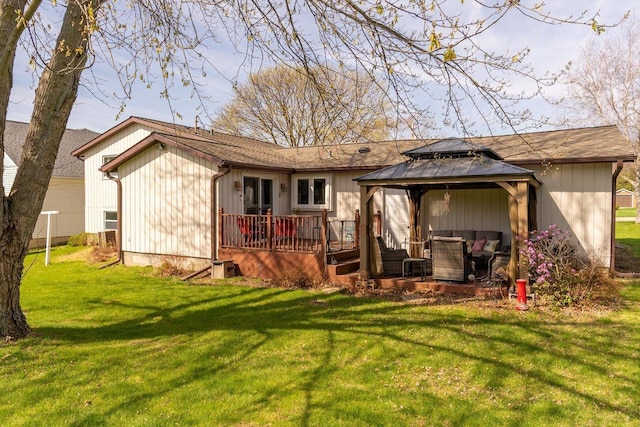 back of house featuring a gazebo, a yard, and a wooden deck