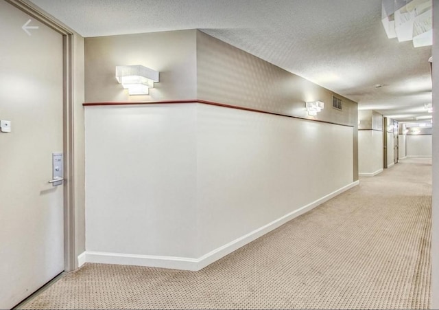 3660 N Lake Shore Dr Unit 711, Chicago, IL 60613 - hallway with light carpet, a textured ceiling, visible vents, and baseboards