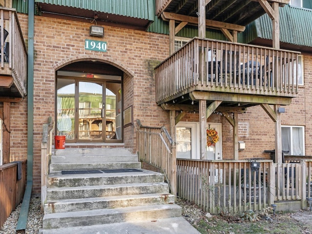 doorway to property with brick siding