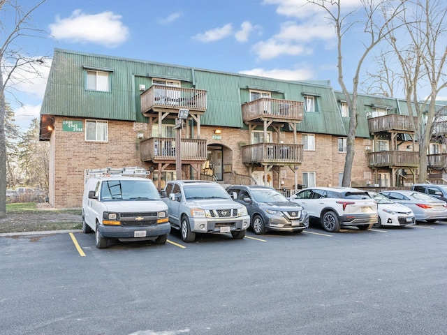 view of building exterior featuring uncovered parking