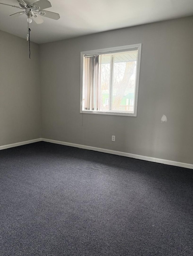 spare room with carpet, baseboards, and ceiling fan