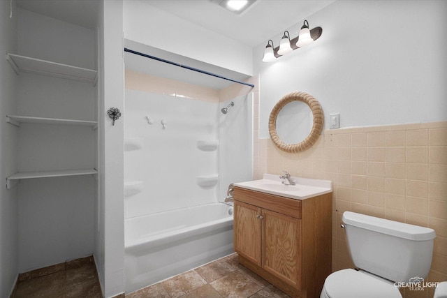 full bath featuring tile walls, toilet, vanity, and shower / washtub combination