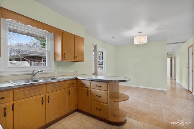kitchen featuring open shelves, a sink, light tile patterned flooring, light countertops, and a peninsula