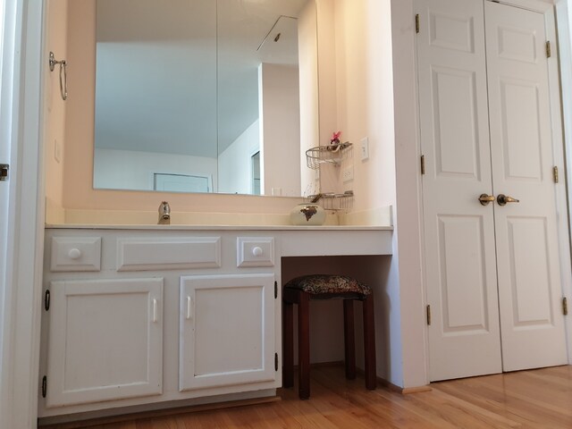 bathroom with vanity and wood finished floors
