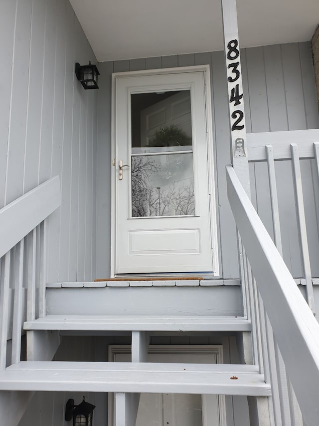 property entrance featuring board and batten siding