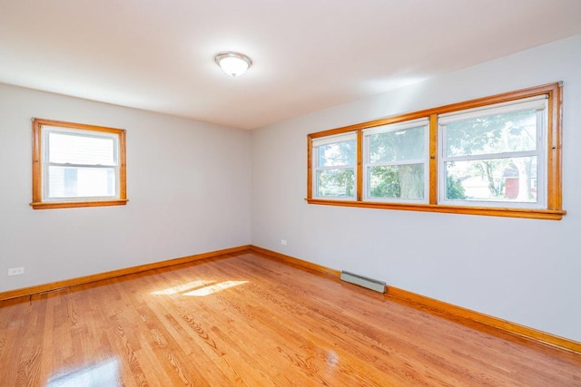 unfurnished room with visible vents, baseboards, and light wood-type flooring