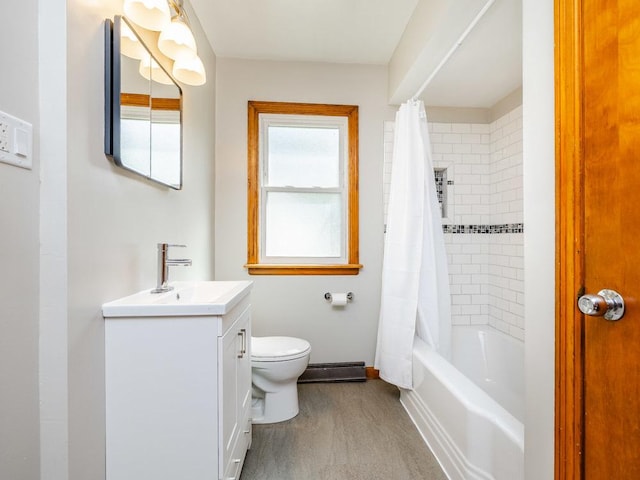 full bath with wood finished floors, vanity, baseboards, toilet, and shower / bathtub combination with curtain