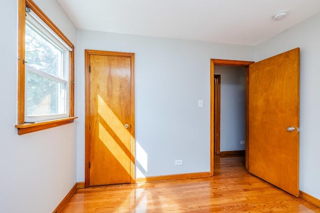 unfurnished bedroom featuring baseboards and light wood finished floors