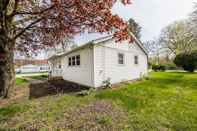 view of side of home featuring a lawn