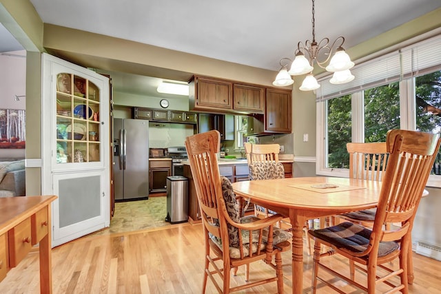 13344 S Stephen Dr, Palos Park, IL 60464 - dining room featuring a chandelier and light wood-style flooring