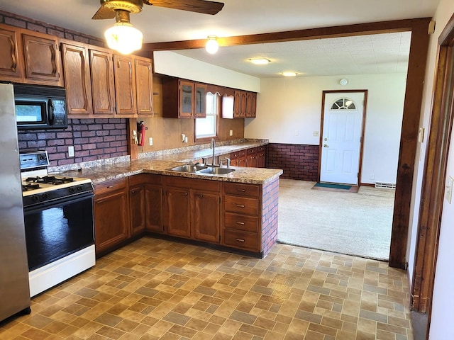 5890 S Il Route 2, Oregon, IL 61061 - kitchen featuring black microwave, a sink, freestanding refrigerator, a peninsula, and gas range oven