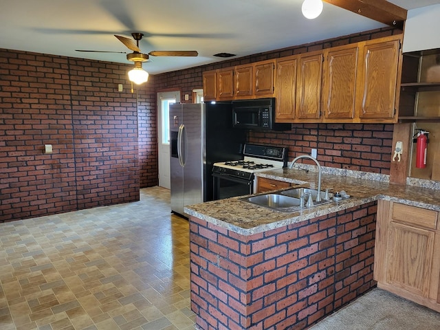 5890 S Il Route 2, Oregon, IL 61061 - kitchen featuring ceiling fan, brick wall, a sink, and gas stove