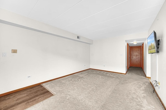 carpeted spare room with baseboards