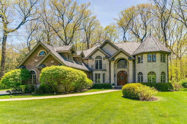 14705 W Mayland Villa Rd, Lincolnshire, IL 60069 - view of front facade with stone siding and a front lawn