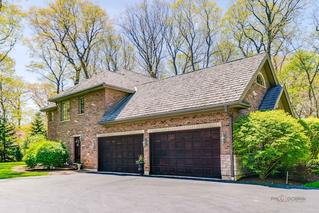 14705 W Mayland Villa Rd, Lincolnshire, IL 60069 - view of side of property featuring brick siding, asphalt driveway, and a garage