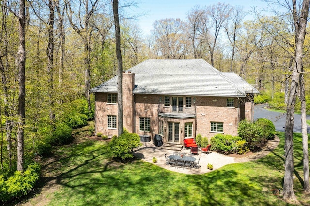 14705 W Mayland Villa Rd, Lincolnshire, IL 60069 - back of property with french doors, a balcony, a lawn, a patio, and brick siding