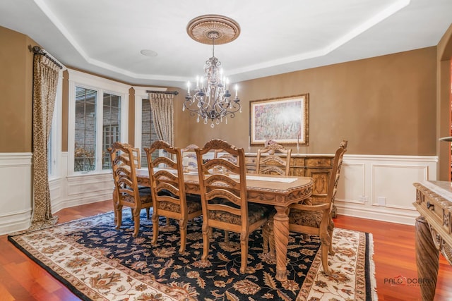 14705 W Mayland Villa Rd, Lincolnshire, IL 60069 - dining area with a chandelier, a tray ceiling, wood finished floors, wainscoting, and a decorative wall