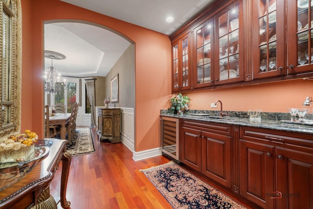 14705 W Mayland Villa Rd, Lincolnshire, IL 60069 - indoor wet bar featuring wine cooler, arched walkways, wood finished floors, a chandelier, and recessed lighting