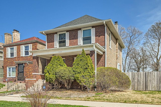 7525 S Crandon Ave, Chicago, IL 60649 - traditional style home featuring fence, a chimney, brick siding, and roof with shingles