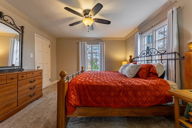 bedroom featuring carpet flooring, baseboards, and a ceiling fan