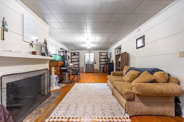 living room with a fireplace with flush hearth and wood finished floors
