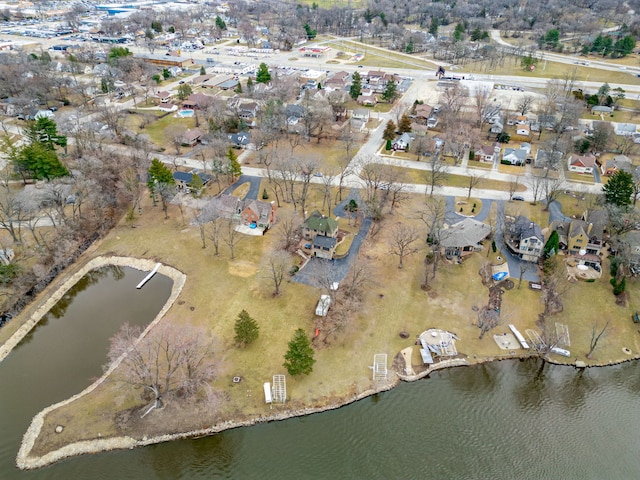 birds eye view of property with a water view and a residential view