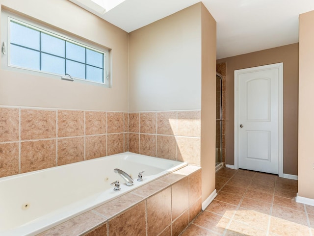 full bathroom featuring a shower stall, a whirlpool tub, baseboards, and tile patterned floors