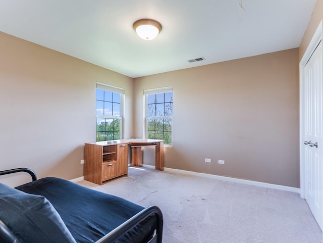 bedroom with baseboards and light colored carpet