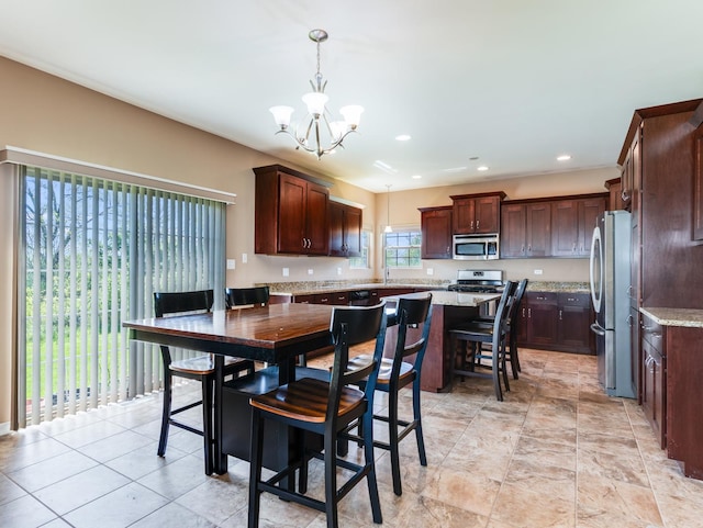 dining space with a chandelier and recessed lighting
