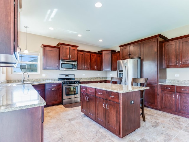 kitchen featuring stainless steel appliances, a sink, a center island, light stone countertops, and recessed lighting