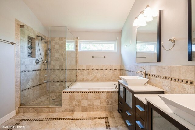 bathroom with a shower stall, a garden tub, tile patterned flooring, and vanity