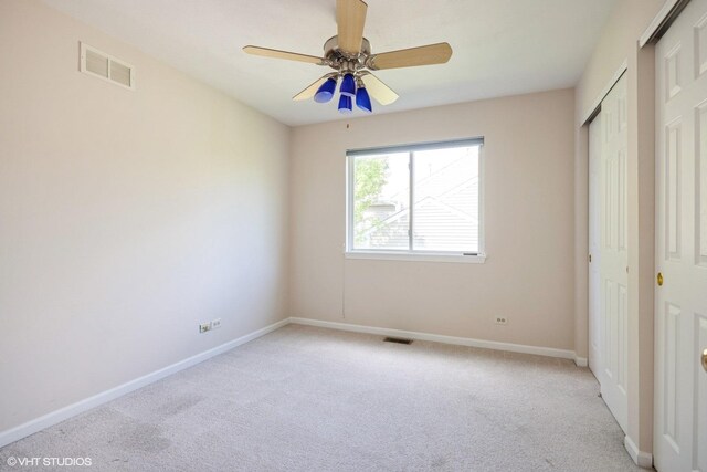 unfurnished bedroom featuring light carpet, baseboards, and a closet