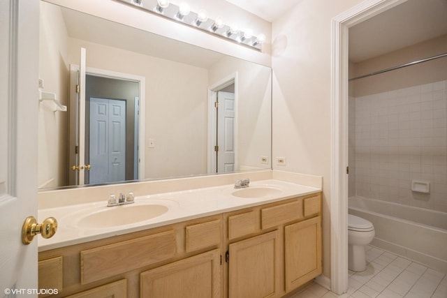 bathroom featuring toilet, double vanity, tile patterned flooring, and shower / washtub combination