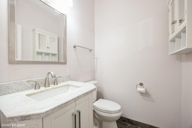 half bathroom with toilet and vanity