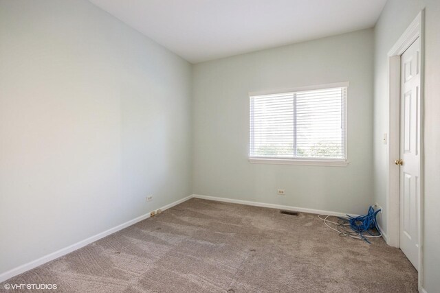 empty room with carpet flooring and baseboards