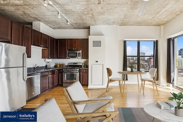 kitchen featuring light wood-style floors, stainless steel appliances, visible vents, and track lighting