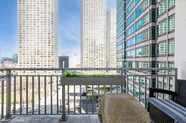 balcony with a view of city and a grill