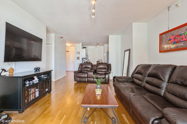 living room featuring baseboards and light wood finished floors