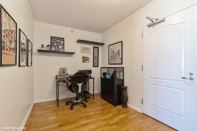 office space with wood finished floors and baseboards