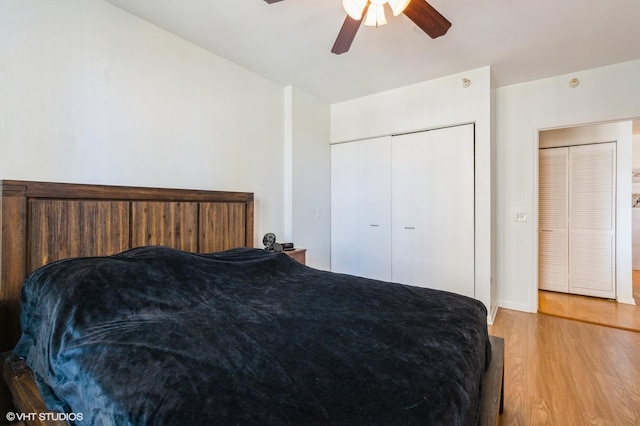 bedroom with light wood-style floors, a closet, baseboards, and ceiling fan