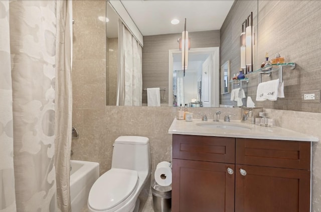 full bathroom with shower / bath combination with curtain, vanity, tile walls, and toilet