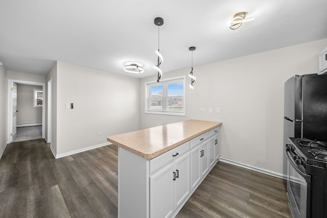 kitchen featuring freestanding refrigerator, dark wood-type flooring, a peninsula, black range with gas cooktop, and white cabinets