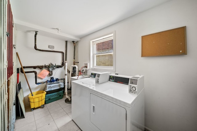 shared laundry area featuring separate washer and dryer and light tile patterned flooring