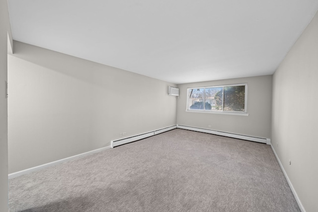carpeted spare room featuring an AC wall unit, baseboards, and a baseboard radiator