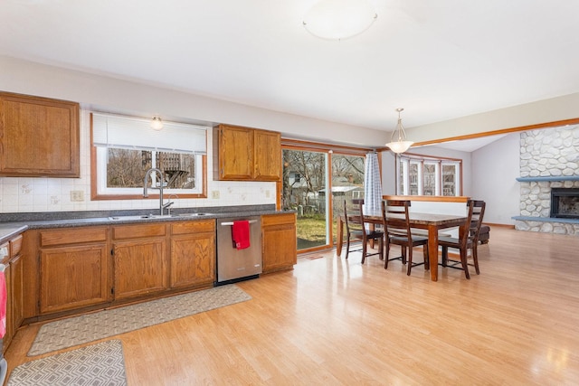 2084 Maplewood Cir, Naperville, IL 60563 - kitchen with light wood-style flooring, brown cabinets, stainless steel dishwasher, and a sink